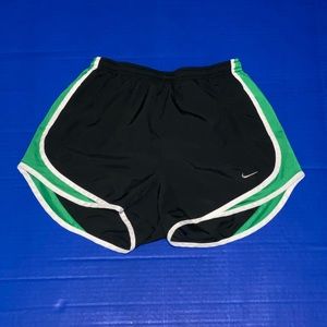 Black and green nike running shorts